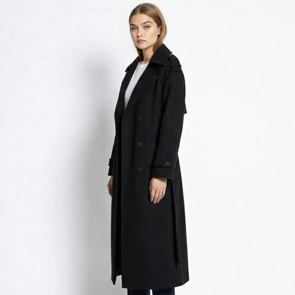 Woman wearing a long double-breasted belted trench coat
