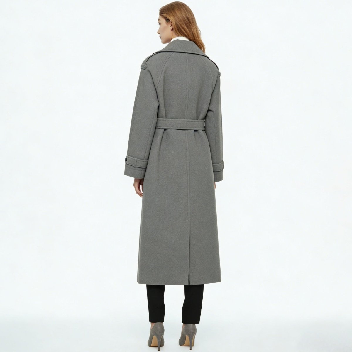 Woman wearing a long double-breasted belted trench coat