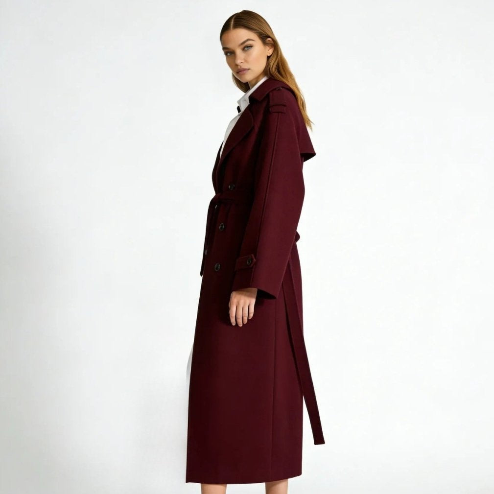 Woman wearing a long double-breasted belted trench coat
