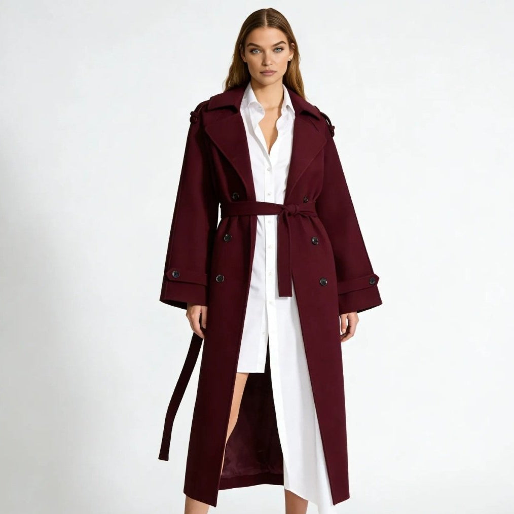 Woman wearing a long double-breasted belted trench coat