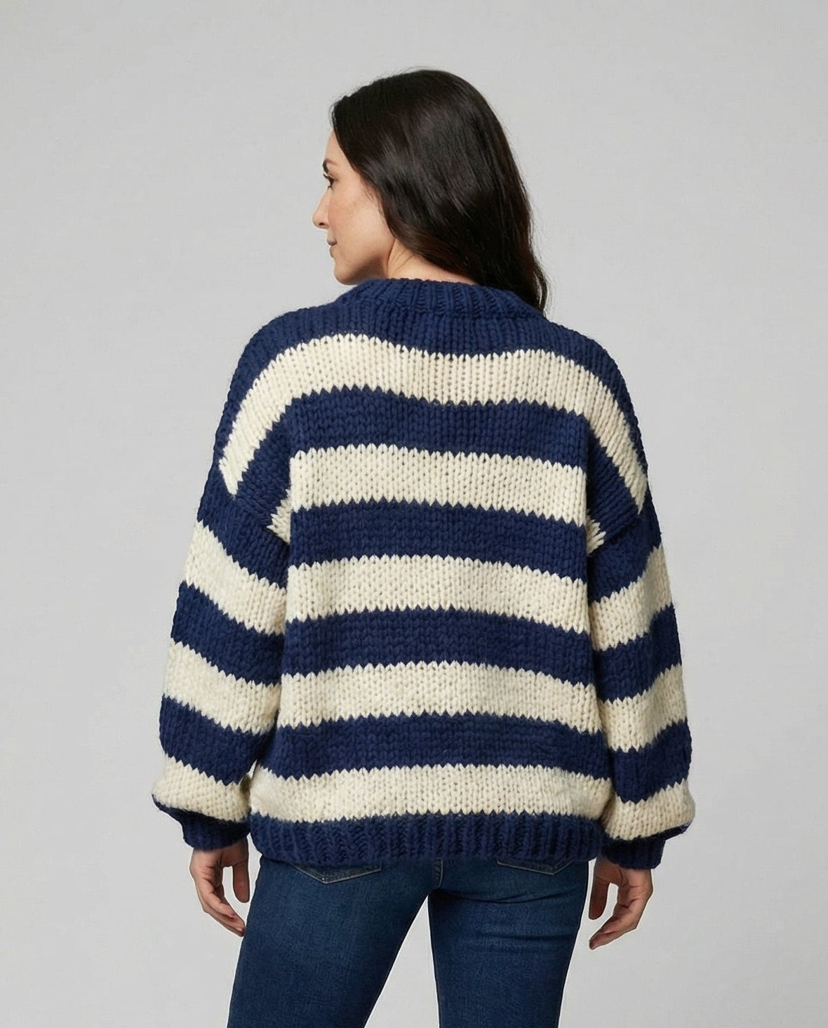Woman wearing a striped oversized knit sweater