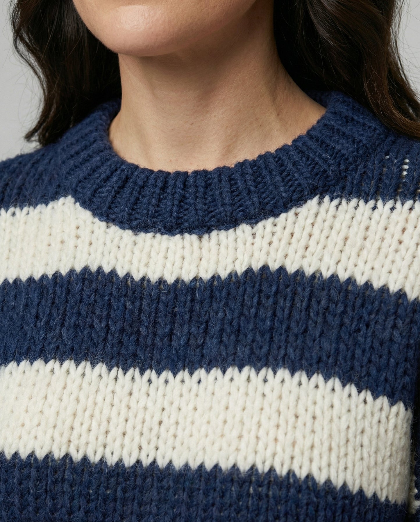 Woman wearing a striped oversized knit sweater