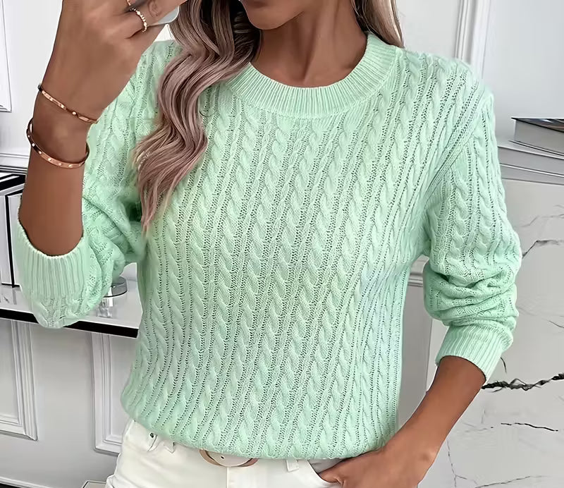 Woman wearing a cable knit crewneck pullover sweater