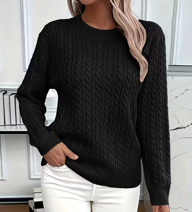 Woman wearing a cable knit crewneck pullover sweater