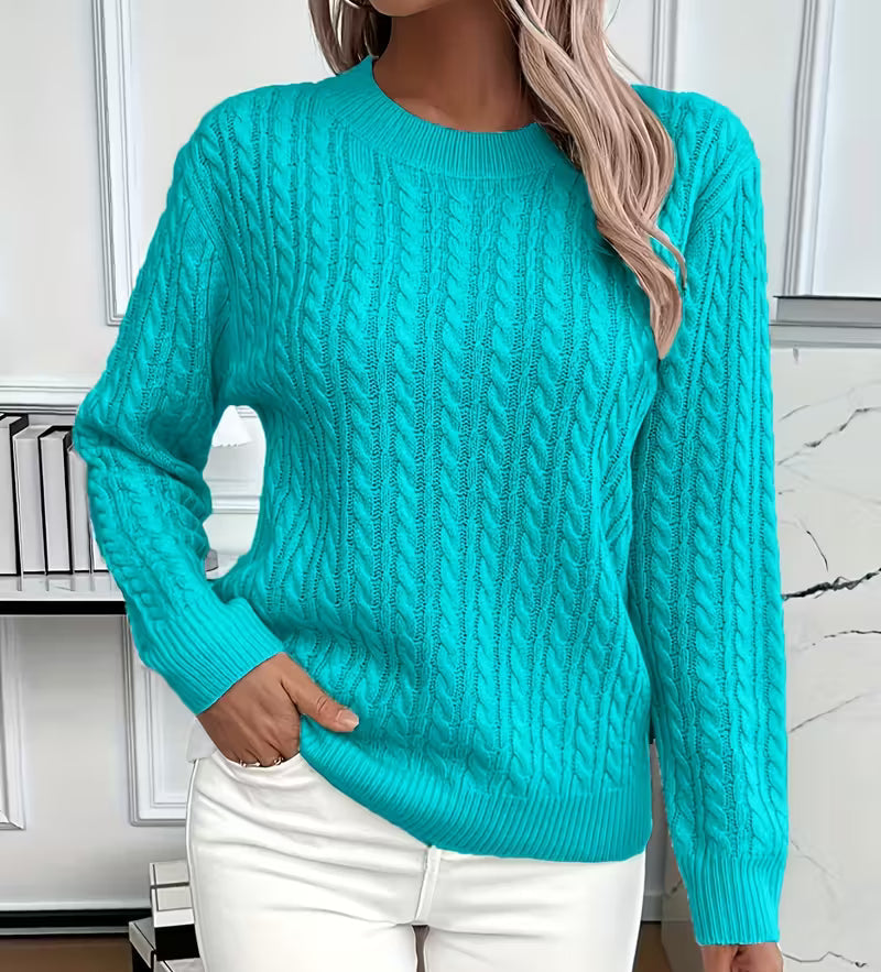 Woman wearing a cable knit crewneck pullover sweater