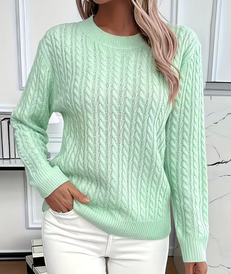 Woman wearing a cable knit crewneck pullover sweater