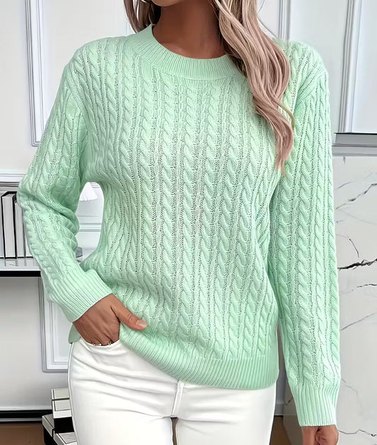 Woman wearing a cable knit crewneck pullover sweater