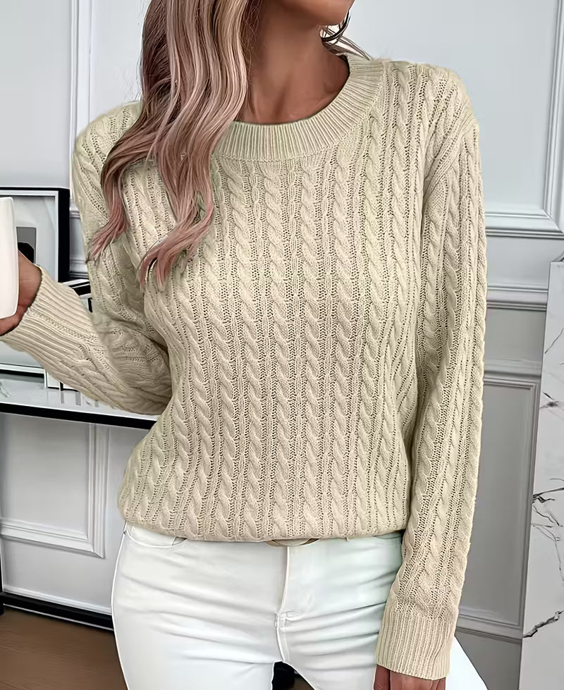 Woman wearing a cable knit crewneck pullover sweater