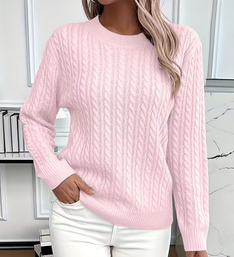 Woman wearing a cable knit crewneck pullover sweater