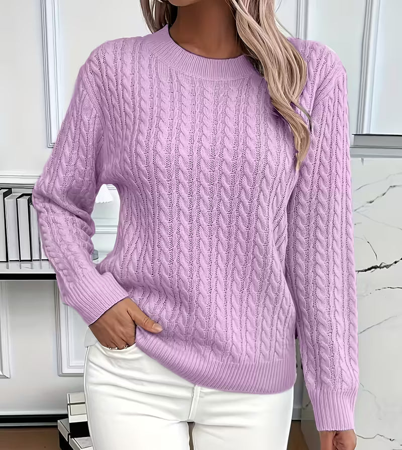 Woman wearing a cable knit crewneck pullover sweater