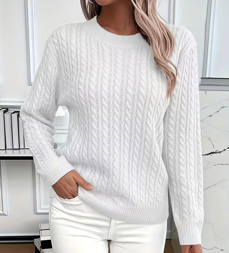Woman wearing a cable knit crewneck pullover sweater