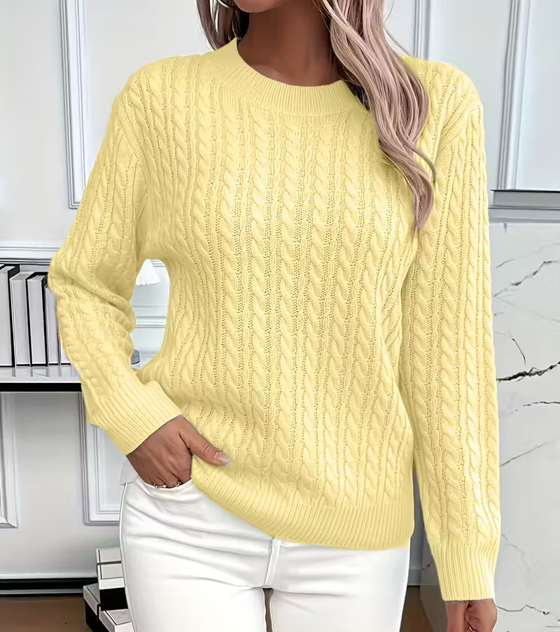 Woman wearing a cable knit crewneck pullover sweater