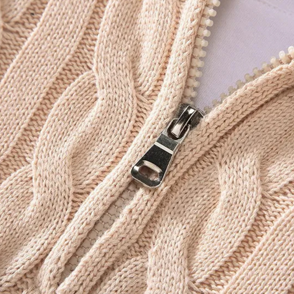 Man wearing a cable knit half zip sweater