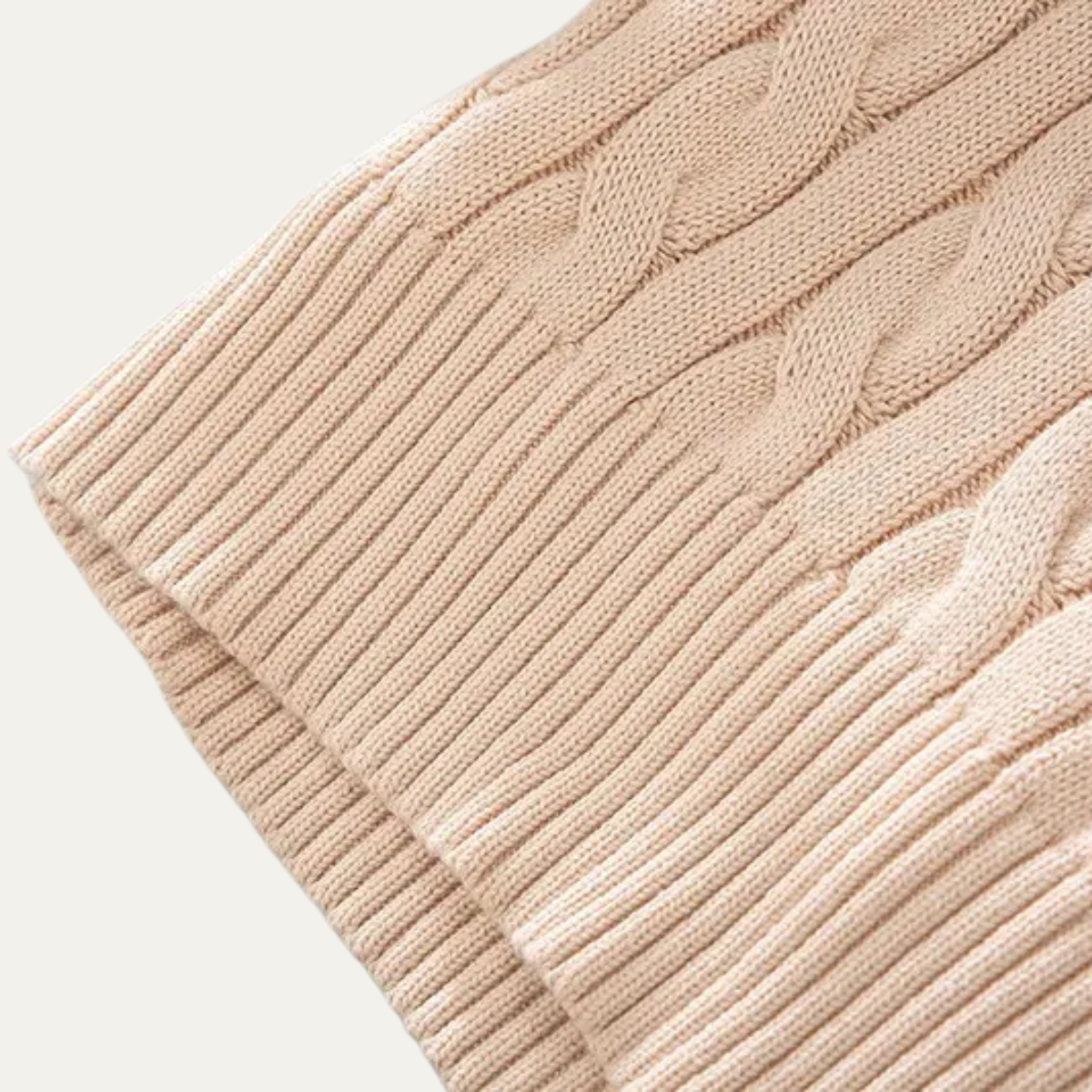 Man wearing a cable knit half zip sweater