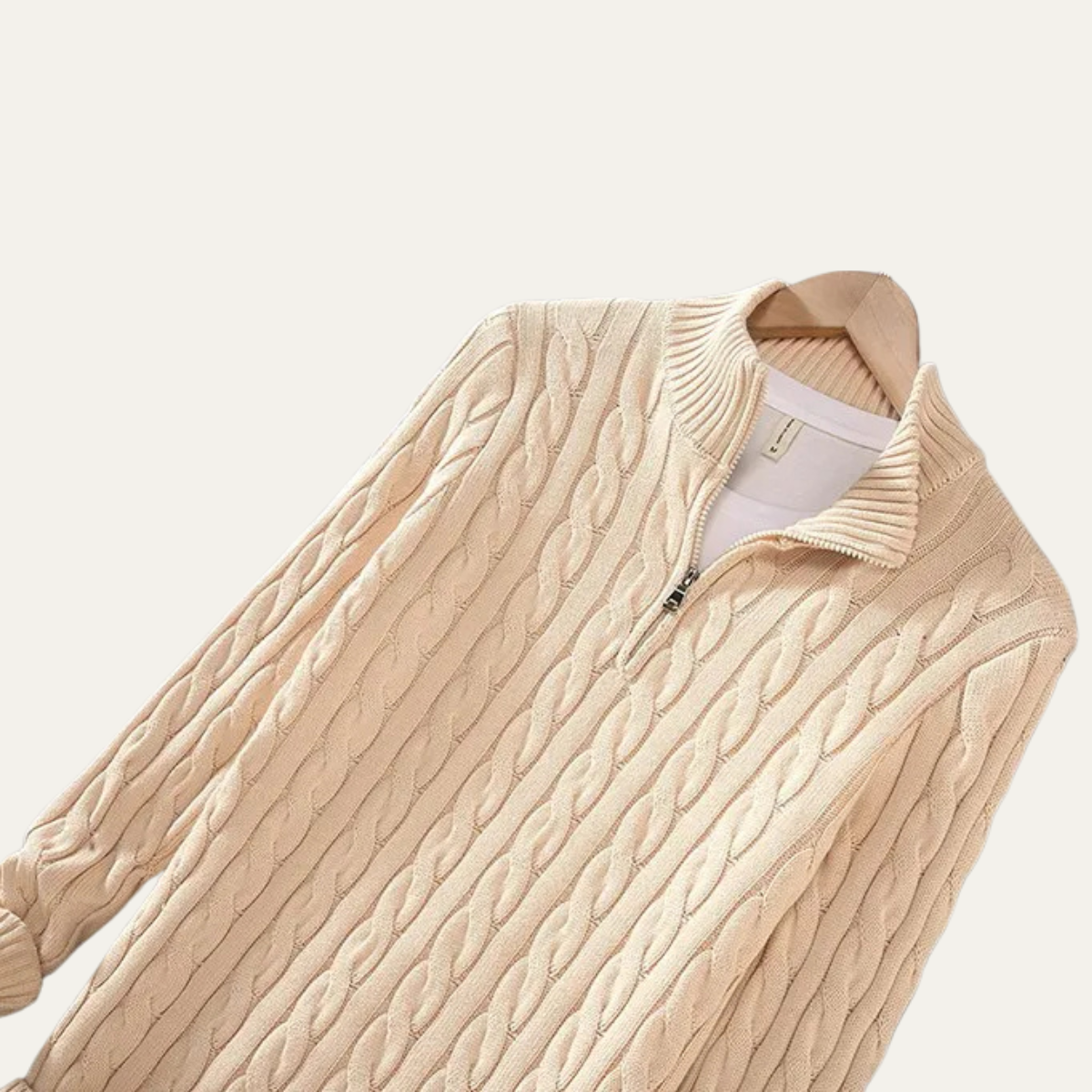 Man wearing a cable knit half zip sweater