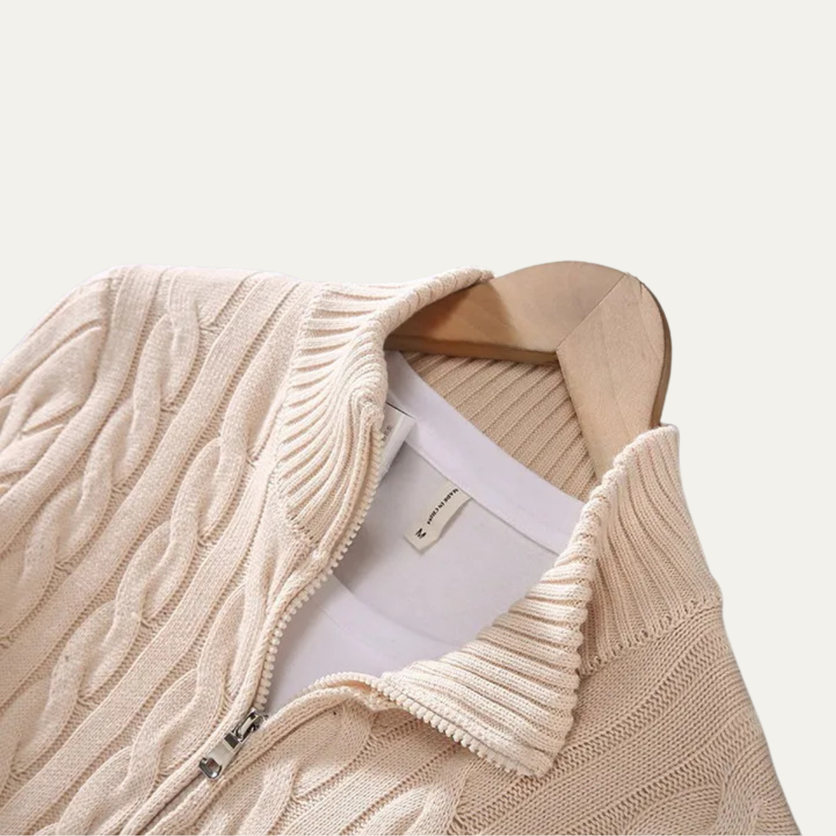 Man wearing a cable knit half zip sweater