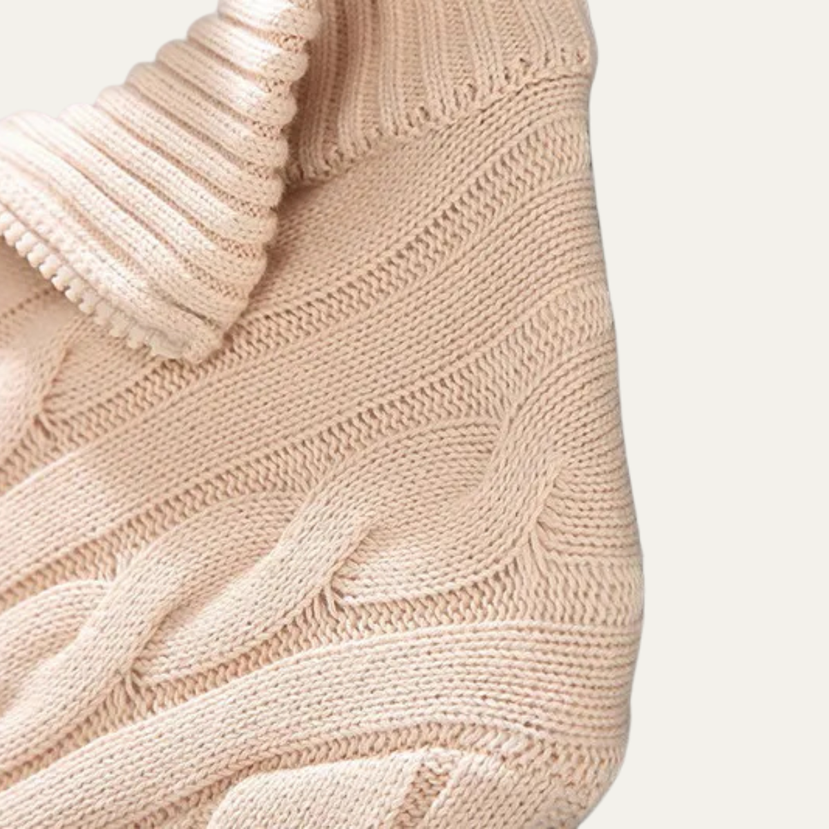 Man wearing a cable knit half zip sweater