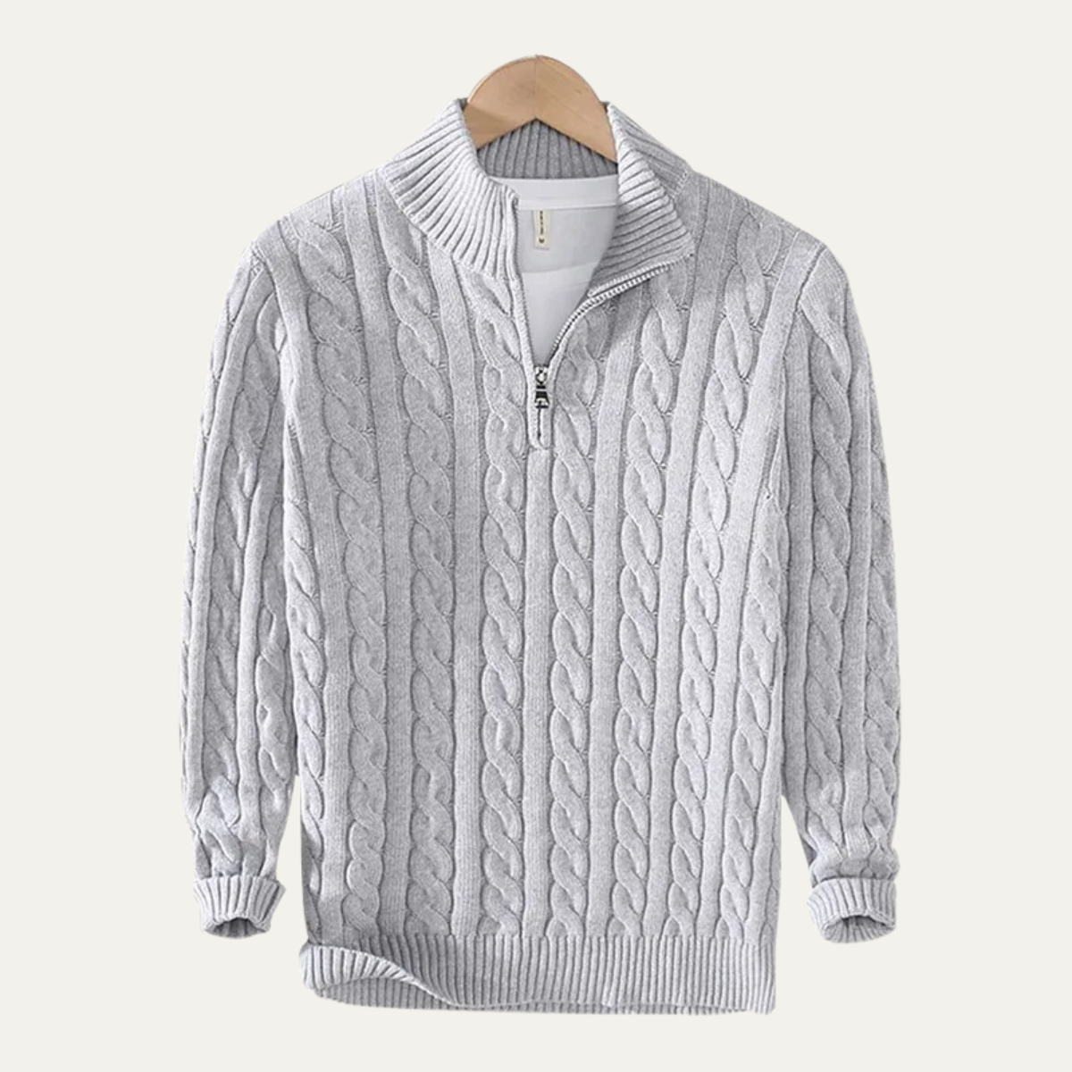 Man wearing a cable knit half zip sweater