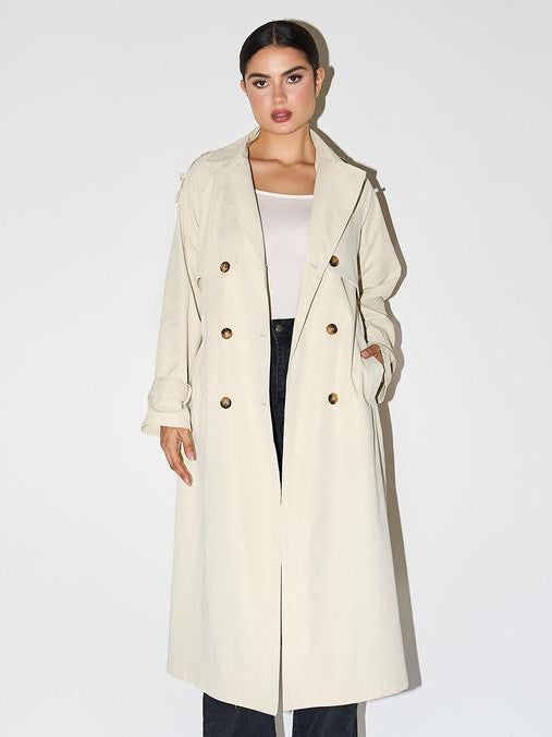 Woman wearing an elegant double breasted longline trench coat