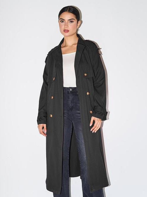 Woman wearing an elegant double breasted longline trench coat