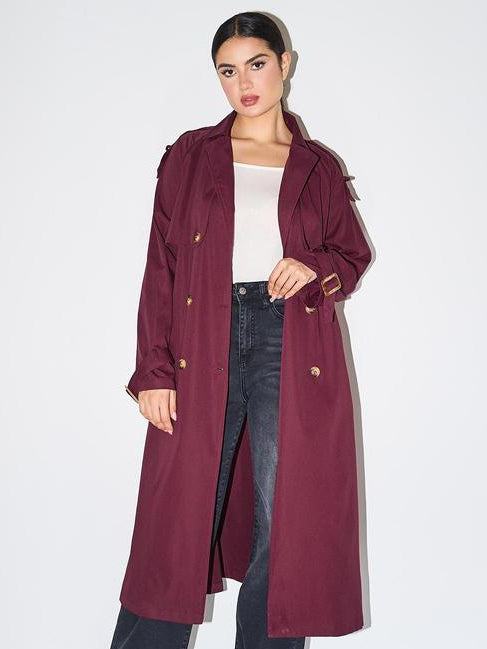 Woman wearing an elegant double breasted longline trench coat