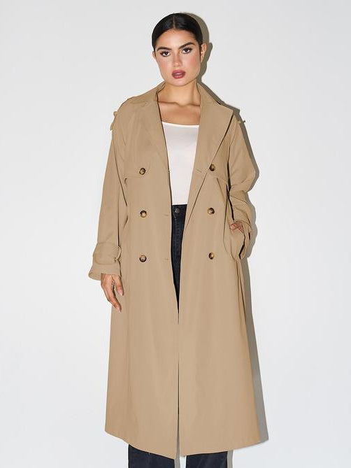 Woman wearing an elegant double breasted longline trench coat