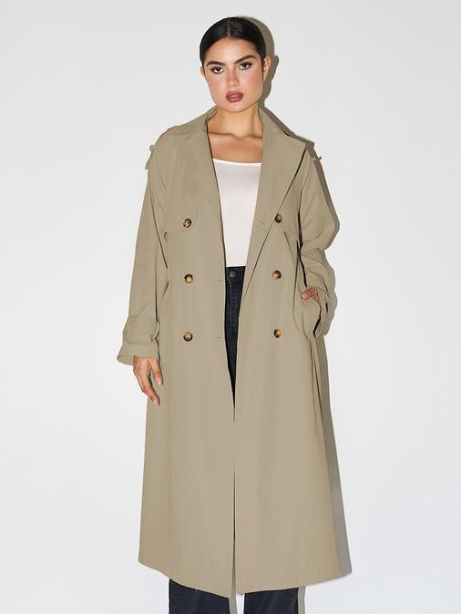 Woman wearing an elegant double breasted longline trench coat